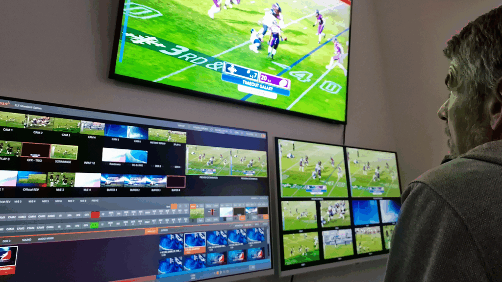 A man directs the ELF football game live, featuring live stream graphics created with VIZRT character generator software